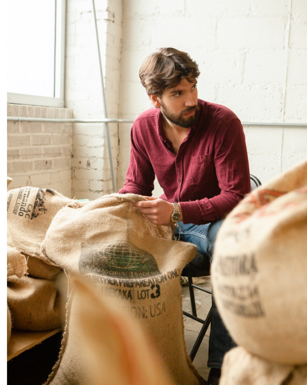 Redhawk Coffee Roasters boy with his coffee bags.