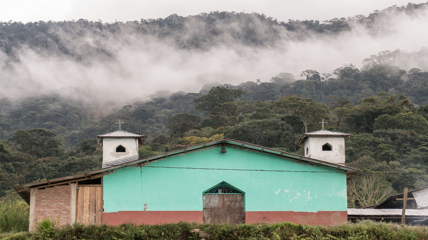 Redhawk Coffee Roasters teal building in Brazil coffee farm